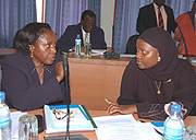 MP Nusura Tiperu (right) talks to MP Odette Nyiramirimo of Rwanda during an EALA session recently.