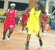 Rwandau2019s Laetitia Mahoro drives past Ugandau2019s Olivia Mulwana in yesterday game. Mahoro was Rwandau2019s second highest scorer with 23 points. (Photo / G. Barya)
