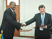 Minister James Musoni and Ambassador Cannon after signing the MoU at the MINECOFIN offices. (Photo G Barya).