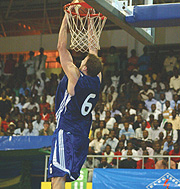 Rwandau2019s Robert Thompson scores through a dunk against Burundi on Wednesday this week.(Photo / G. Barya).