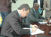 Finance and economic Planning Minister James Musoni signing the Methane gas deal with Joseph Brandt Presindent and Chief Executive of Contour Global yesterday.(Photo/ G. Barya)