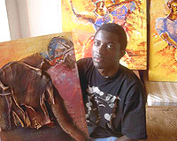 Collin Sekajugo the founder and director of Ivuka Arts Kigali and RwaMakondera, displaying one of his art pieces. (File photo).