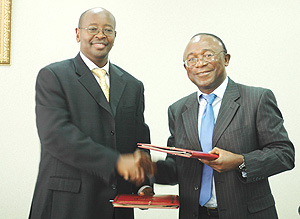 Minister of Finance and Economic Planning James Musoni shakes hands with ADB Resident Representative Diko Mukete after signing the Grant. ( Photo / G. Barya).