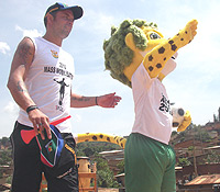 MOBILISATION: Ex-South African players Mark Fish unveils the 2010 World Cup Official Mascot Zakumi yesterday in Kimisagara, Kigali. 
