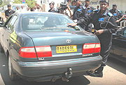 Acting Comissioner General of Police Mary Gahonzaire putting an anti corruption sticker on car to mark the beginning of the anti-corruption week yesterday. (Photo /G. Barya).