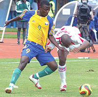 POWER:  Elias Uzamukunda leaves his Malian opponent for dead during the African Youth Championship in Kigali. The APR striker is having professional trials with French club Fc Nantes.