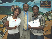 Some of the graduands in at the Film Institute, Tega Mutimura (L) and Yves Gahinde pose for a photo with Minister Mutsindashyaka after their graduation. (Courtsey Photo).
