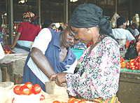 A market Vendor helps a woman pick machandise: Small, medium, and big investors will have to comply with the PSF ethical standards. (File Photo)