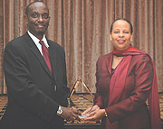Health Minister Dr Richard Sezibera receiving the Global Health Progress award on behalf of First Lady Jeannette Kagame from Alicia D. Greenidge for outstanding Leadership in advancing access to HIV/AIDS treatment in Rwanda. (Photo/G.Barya).