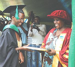 Education Minister Daphrose Gahakwa awards Charity Kagenza the overall best student at SFB during the graduation ceremony yesterday. (Photo/ G. Barya).