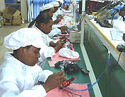 Women assembling mobile phones at the A-Link Technologies premises in Kacyiru. They will assemble laptops in the company brand A-Link soon this year. 