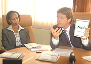 The Managing Director Bralirwa Sven Piederiet displays the companyu2019s new logo yesterday. Looking on is Bralirwau2019s HR Manager Sonia Kubwimana. (Photo/J.Mbanda).