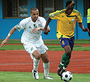 Patrick Mafisango dribbles past Algeriau2019s Madjid Bougherra .the game ended scoreless.  (Photo / G. Barya)