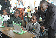 State Minister for Primary and Secondary Education Theoneste Mutsindashyaka inspects  Pupils using laptops At Green Hills Academy yesterday. (Photo/ G. Barya).