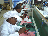 Ladies assembling Alira phones.