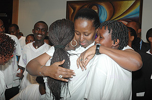 First Lady Jeannette Kagame consoles two young Genocide survivors at a  meeting organised by Imbuto Foundation. (Photo/ J. Mbanda).