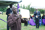 Geoffrey Kasumba displays the certificate of appreciation he received for his efforts. (Photo/ B. Namata).