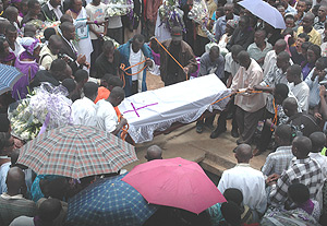 Remains of Genocide victims from Kicukiro District  being lowered into a  grave at Gisozi Memorial Centre yesterday. (Photo G.Barya).