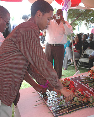 One of the children of US Embassy staff slain during the Genocide lays flowers on the remembrance monument yesterday. (Photo/ G. Barya).