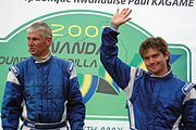 Zimbabweu2019s Conrad Rautenbach (R) waves to the crowd after winning the 2007 Rwanda Mountain Gorilla rally (File Photo)