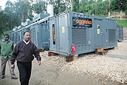 Minister Albert Butare walks past the Aggreko generators last year. (File Photo).
