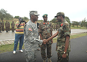 Gen William Ward  (L) is welcomed by the Commandant of Gabiro School of Infantry Maj. Gen. Martin Nzaramba as Gen. James Kabarebe looks on. (Photo/ J. Mbanda).