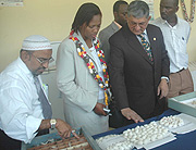 UTEXRWA Managing Director Raj- Rajendran (2nd right) explains to the Kigali City Vice Mayor Jeanne du2019Arc Gakuba how silk worms produce thread recentlty. (File Photo).