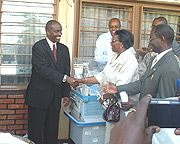 Health Minister, Dr. Richard Sezibera shakes hands with Madame Therese Zeba the UNFPA Resident Representative. (Courtsey Photo).