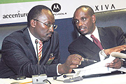 Health Minister Richard Sezibera (R) consults with MTN COO Andrew Rugege during the meeting at Prime Holdings on Thursday. (Photo J Mbanda).