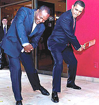 THIS IS HOW ITu2019S DONE:  Lara gives Obama some batting tips.