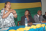 Pelagie Muhorakeye (L) communicates in sign language while Minister Mujawamariya looks on . Right is John Mutamba from UNIFEM. (Photo J. Mbanda).