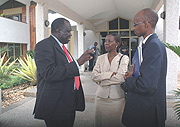 Justice Minister Tharcisse Karugarama (L) talks to Information Minister Louise Mushikiwabo (C) and ORINFORu2019s Willy Rukundo outside Parliament yesterday after the presentation of the amended Media Bill. 