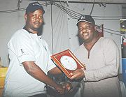 Davis Kashaka (R) shows off his winneru2019s award alongside KGC president Jack Kayonga.(Photo /G.Barya)