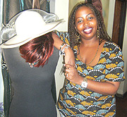 Amani Kalisa poses happily on one of her works.