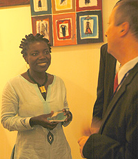 Sandra Idossou speaks to guest.