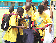 Children admire some of the sports bags they received during the event (Photo G Barya)