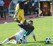 Saidi Abedi tries to protect the ball during Amavubiu2019s goalless 2010 World Cup/CAN qualifier against Algeria. (Inset is Jean Baptiste Kayiranga)