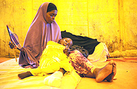 A woman sat recently with her 7-year-old son, who had been wounded by a stray bullet, in a medical tent set up by Ugandan forces in Mogadishu, Somalia 