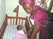 Kigali Mayor Dr Aisa Kirabo Kacyira gives care to a baby in a child home during her tour yesterday. (Photo/ S. Nkurunziza).