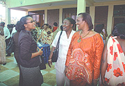 The Speaker of the Lower Chamber, Rose Mukantabana (R) chatting with members of the NWC after the meeting.