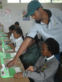 Green Hills children getting instruction on how to use their laptops (G-Barya)