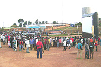 Residents glue their eyes to the giant screen at Byumbau2019s taxi park (Photo by A.Gahene)