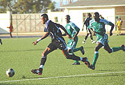 EYES ON THE BALL:  APRu2019s Patrick Mafisango beats two Ulinzi players during yesterdayu2019s clash played at Nyamirambo stadium. APR won the contest 3-2 to book their place in the semifinal. (Photo/ J. Mbanda)