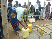 Refugees fetch water at one of the water taps constructed by  ARC during the day.(Photo Dan Ngabonziza)