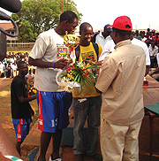 Ecole Technique St Joseph team captain receives the winners trophy. (Photo P. Ntambara)