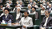 Iranian President Mahmoud Ahmadinejad, center, listens to a speech in Iranian parliament.