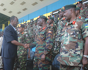 Prime Minister Bernard Makuza greets Ugandan Army Chief Gen. Aronda Nyakairima during the closure of the East African Sports and Cultural week that brought together EAC armed forces at Amahoro Stadium yesterday. (Photo/ J Mbanda)