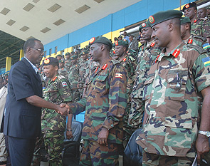 Prime Minister Bernard Makuza greets Ugandan Army Chief Gen. Aronda Nyakairima during the closure of the East African Sports and Cultural week that brought together EAC armed forces at Amahoro Stadium yesterday. (Photo/ J Mbanda)