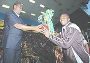 The Prime Minister Bernard Makuza giving the EAC Military Games trophy to APR goalie Jean Claude Ndoli yesterday at Amahoro stadium.(Photo/ J.Mbanda)