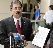 Ousted Honduras President Manuel Zelaya holds a diplomatic note from the U.S. State Department after meeting with U.S. Secretary of State Hillary Clinton in Washington on July 7